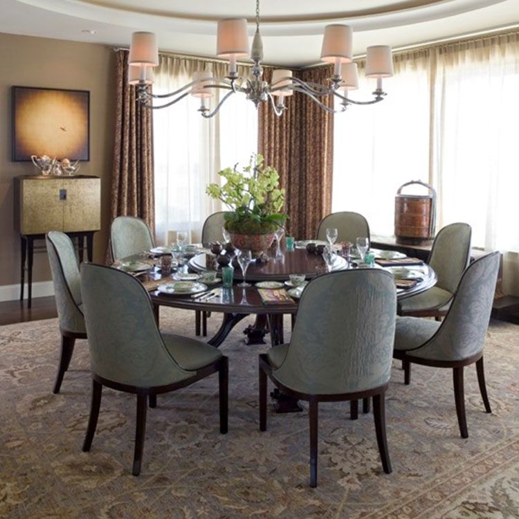 Modern dining room with large round table set for 8.